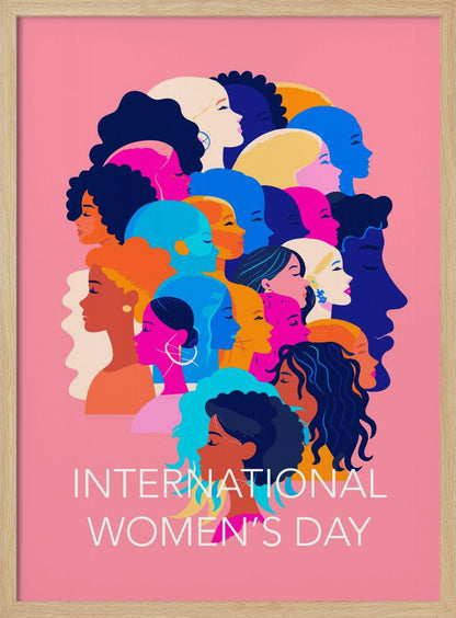 A vibrant poster for International Women's Day featuring a pink background. The central graphic is a collage of colorful profiles of diverse women, representing different ethnicities and hairstyles, all looking in the same direction. Below the illustration, white text reads 'INTERNATIONAL WOMEN'S DAY'. Wall Art