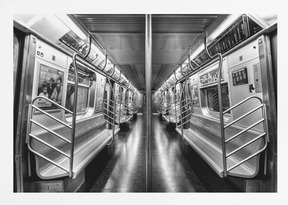 A framed, black and white photograph capturing a perfectly symmetrical view down the aisle of an empty subway car. The reflective, dark floor and the metallic seats and handrails create strong leading lines, giving the image a sense of depth and urban solitude. Wall Art