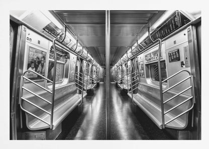 A framed, black and white photograph capturing a perfectly symmetrical view down the aisle of an empty subway car. The reflective, dark floor and the metallic seats and handrails create strong leading lines, giving the image a sense of depth and urban solitude. Wall Art