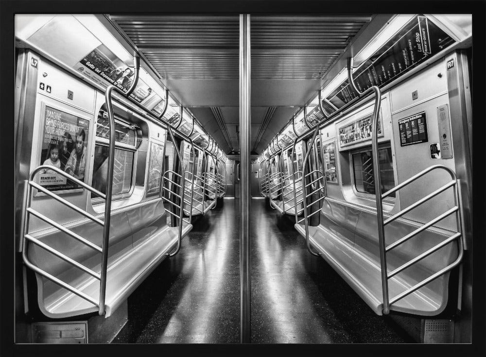 A framed, black and white photograph capturing a perfectly symmetrical view down the aisle of an empty subway car. The reflective, dark floor and the metallic seats and handrails create strong leading lines, giving the image a sense of depth and urban solitude. Wall Art
