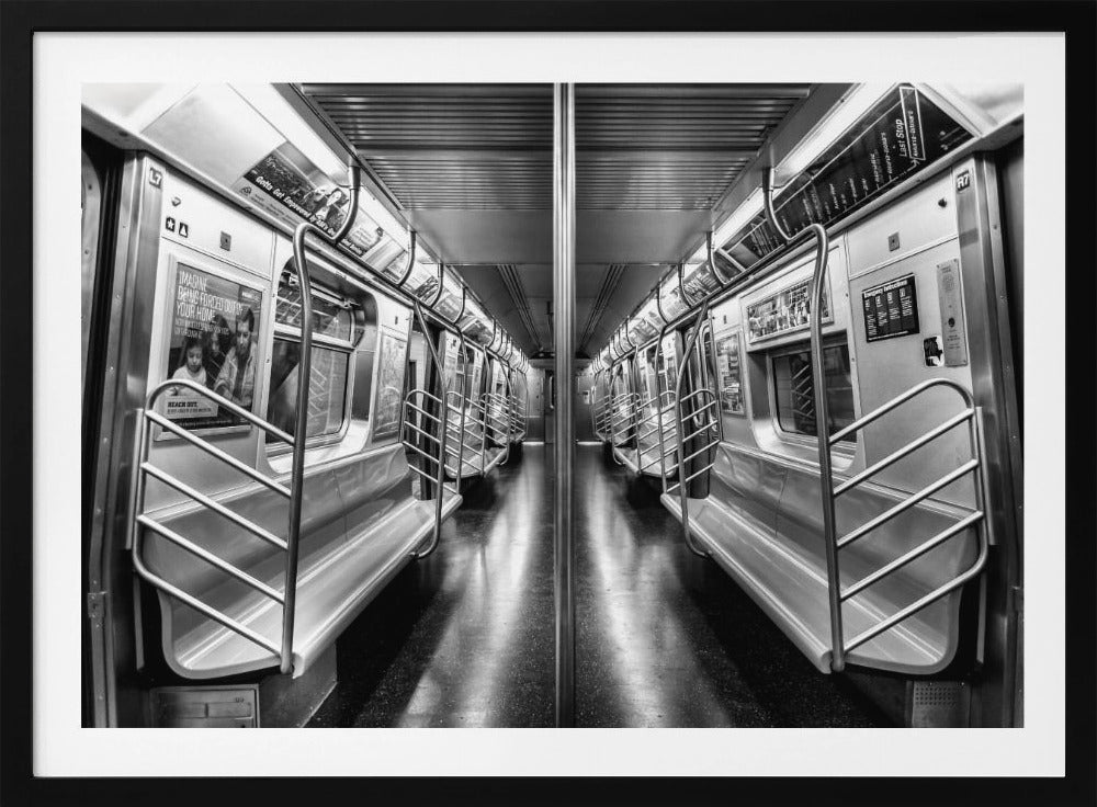 A framed, black and white photograph capturing a perfectly symmetrical view down the aisle of an empty subway car. The reflective, dark floor and the metallic seats and handrails create strong leading lines, giving the image a sense of depth and urban solitude. Wall Art