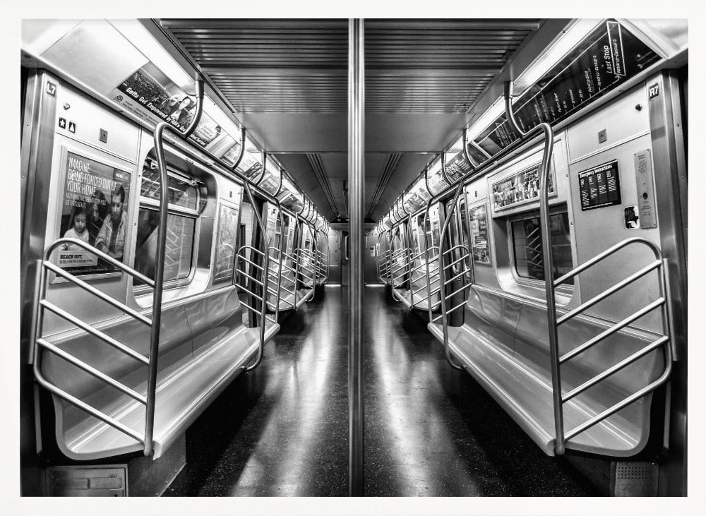 A framed, black and white photograph capturing a perfectly symmetrical view down the aisle of an empty subway car. The reflective, dark floor and the metallic seats and handrails create strong leading lines, giving the image a sense of depth and urban solitude. Wall Art