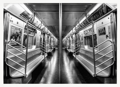 A framed, black and white photograph capturing a perfectly symmetrical view down the aisle of an empty subway car. The reflective, dark floor and the metallic seats and handrails create strong leading lines, giving the image a sense of depth and urban solitude. Wall Art