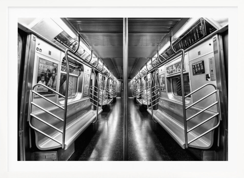A framed, black and white photograph capturing a perfectly symmetrical view down the aisle of an empty subway car. The reflective, dark floor and the metallic seats and handrails create strong leading lines, giving the image a sense of depth and urban solitude. Wall Art