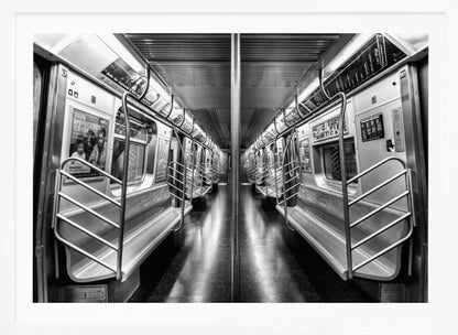 A framed, black and white photograph capturing a perfectly symmetrical view down the aisle of an empty subway car. The reflective, dark floor and the metallic seats and handrails create strong leading lines, giving the image a sense of depth and urban solitude. Wall Art