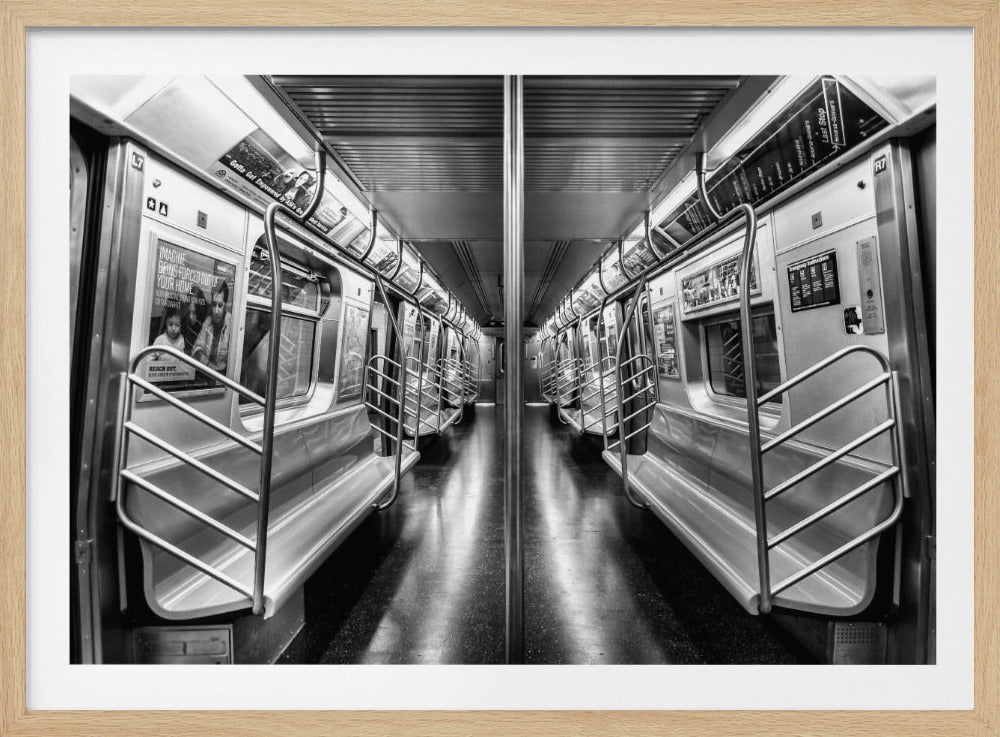 A framed, black and white photograph capturing a perfectly symmetrical view down the aisle of an empty subway car. The reflective, dark floor and the metallic seats and handrails create strong leading lines, giving the image a sense of depth and urban solitude. Wall Art