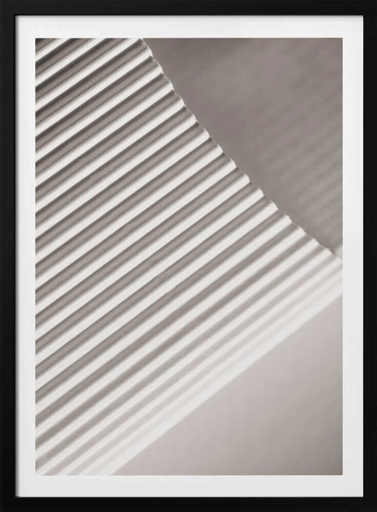 Abstract photograph of a ribbed surface with diagonal lines created by light and shadow, minimalist wall art.