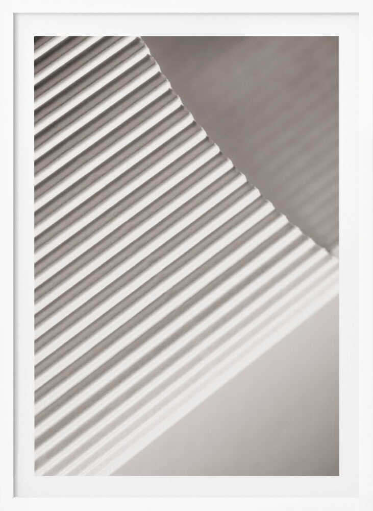 Abstract photograph of a ribbed surface with diagonal lines created by light and shadow, minimalist wall art.