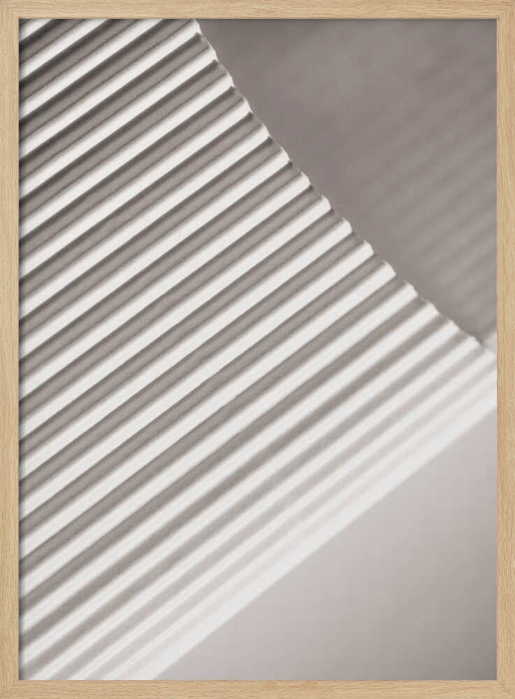 Abstract photograph of a ribbed surface with diagonal lines created by light and shadow, minimalist wall art.