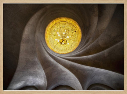 A worm's-eye view of an ornate, golden chandelier set against a swirling, textured dark grey ceiling. The spiraling architectural feature draws the eye to the brightly lit fixture, creating an abstract and dramatic composition. Poster