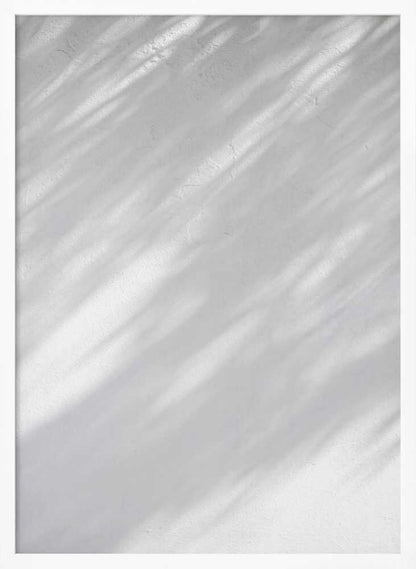 Diagonal leaf shadows cast on a white textured wall, creating a minimalist black and white art piece.