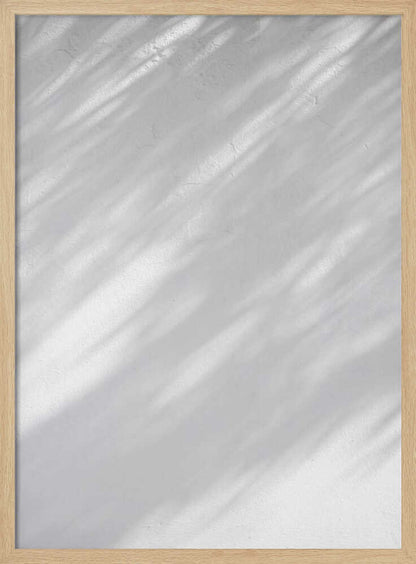 Diagonal leaf shadows cast on a white textured wall, creating a minimalist black and white art piece.