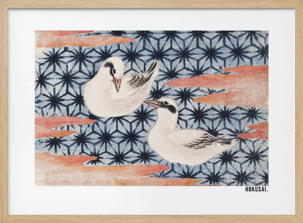 A classic Japanese woodblock print by Hokusai featuring two white birds with black eye markings resting on a background of a traditional blue Asanoha geometric pattern. Soft, reddish-orange cloud-like shapes float across the scene. Print
