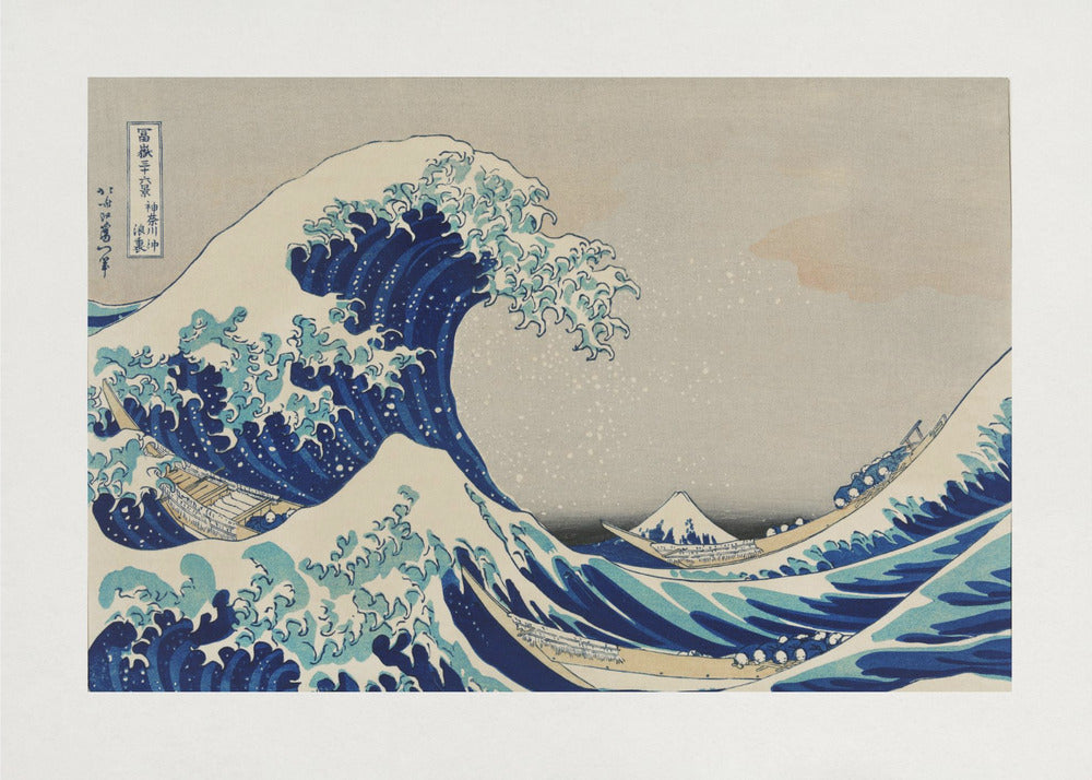 The Great Wave off Kanagawa by Hokusai, a framed Japanese woodblock print depicting a giant, menacing blue and white wave cresting over three boats, with a small Mount Fuji visible in the background under a muted, overcast sky. Artwork