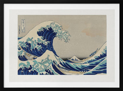 The Great Wave off Kanagawa by Hokusai, a framed Japanese woodblock print depicting a giant, menacing blue and white wave cresting over three boats, with a small Mount Fuji visible in the background under a muted, overcast sky. Artwork