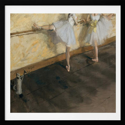 A framed impressionist painting by Edgar Degas depicting two ballet dancers in white tutus practicing at a barre. The studio has a yellow wall and a dark brown wooden floor. One dancer stretches her leg on the barre while the other stands beside her. Artwork