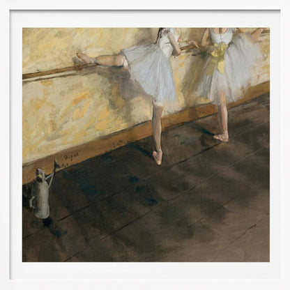 A framed impressionist painting by Edgar Degas depicting two ballet dancers in white tutus practicing at a barre. The studio has a yellow wall and a dark brown wooden floor. One dancer stretches her leg on the barre while the other stands beside her. Artwork