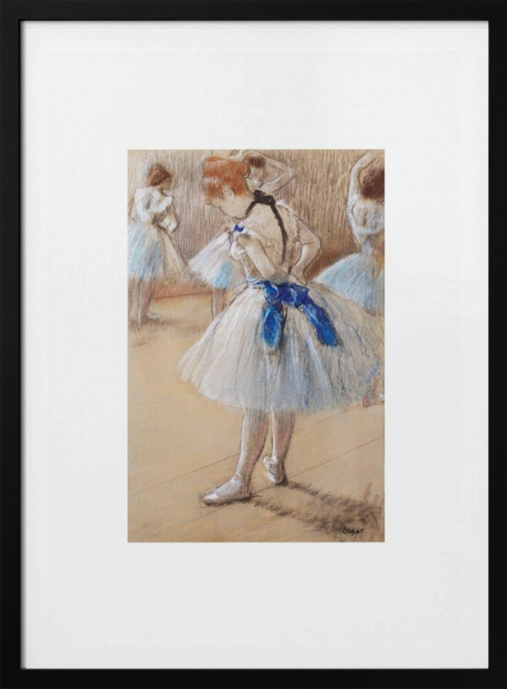 A framed print of an impressionist pastel drawing by Edgar Degas. It shows a ballerina in a white and light blue tutu with a prominent royal blue sash. She is viewed from the side as she adjusts her costume, with other dancers blurred in the background of a dance studio. Poster
