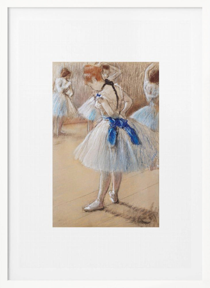 A framed print of an impressionist pastel drawing by Edgar Degas. It shows a ballerina in a white and light blue tutu with a prominent royal blue sash. She is viewed from the side as she adjusts her costume, with other dancers blurred in the background of a dance studio. Poster
