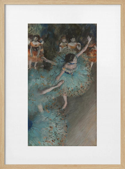 A framed art print of an impressionist painting depicting several ballet dancers on a stage. The central figure is a ballerina in a voluminous light blue tutu, viewed from a high angle. She is mid-pose with arms outstretched. Other dancers in orange and blue costumes are visible in the blurry background. Poster