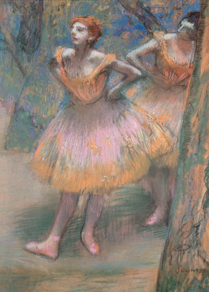 An impressionist pastel painting by Edgar Degas titled 'Dancers in Pink and Orange.' It depicts two ballerinas backstage. The dancer in the foreground has red hair, wears a pink and orange tutu, and stands with her hands on her hips, looking off to the side. A second dancer is partially visible behind her. The background is a textured blend of blues, greens, and browns. Artwork