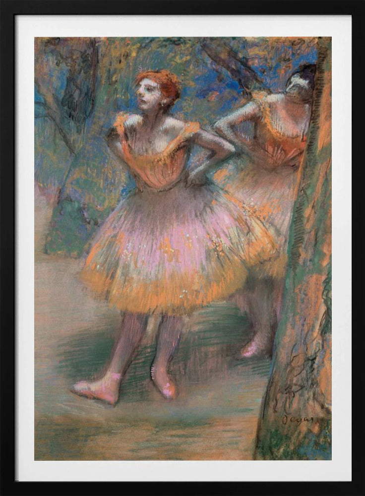 An impressionist pastel painting by Edgar Degas titled 'Dancers in Pink and Orange.' It depicts two ballerinas backstage. The dancer in the foreground has red hair, wears a pink and orange tutu, and stands with her hands on her hips, looking off to the side. A second dancer is partially visible behind her. The background is a textured blend of blues, greens, and browns. Artwork