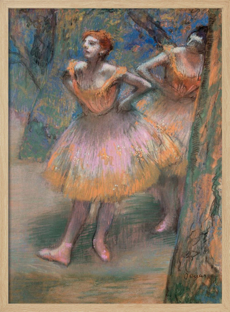 An impressionist pastel painting by Edgar Degas titled 'Dancers in Pink and Orange.' It depicts two ballerinas backstage. The dancer in the foreground has red hair, wears a pink and orange tutu, and stands with her hands on her hips, looking off to the side. A second dancer is partially visible behind her. The background is a textured blend of blues, greens, and browns. Artwork