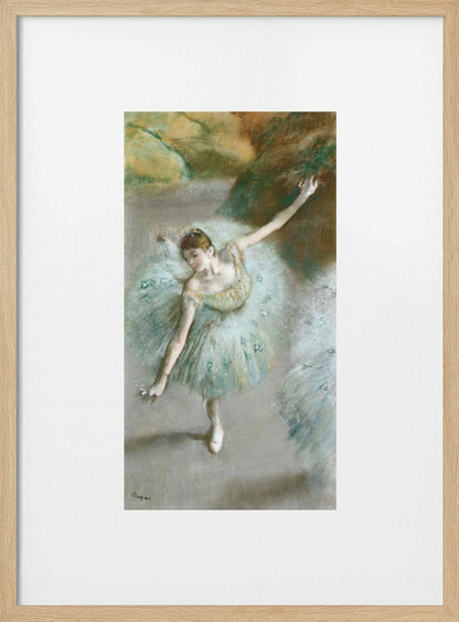 A framed vertical reproduction of an Edgar Degas painting showing a ballerina from a high angle. She wears a voluminous light blue tutu and is posed gracefully with arms outstretched against a soft, impressionistic background of earthy browns and tans. Poster