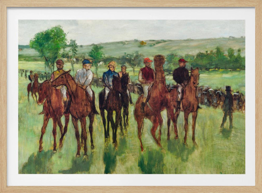An impressionist painting by Edgar Degas titled 'The False Start', depicting a group of jockeys on their racehorses in a verdant field. The riders are dressed in colorful caps and silks, waiting against a backdrop of rolling green hills and a pale sky. The artwork is displayed in a modern silver frame. Artwork