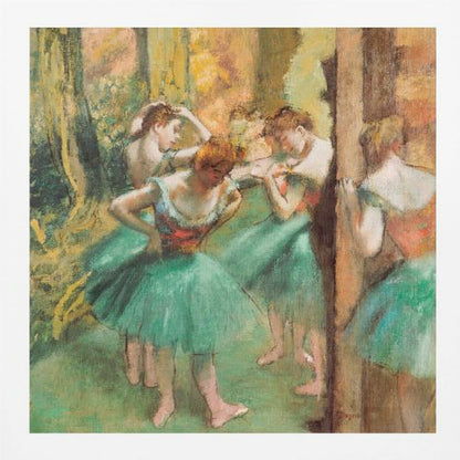 An impressionist painting of four ballet dancers in green tutus backstage. The dancers are adjusting their costumes and hair against a warm, painterly background of yellow, orange, and brown tones. The artwork is displayed in a light wood frame. Wall Art