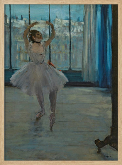 An impressionistic painting by Edgar Degas of a ballerina in a dance studio. The dancer, wearing a white tutu and pointe shoes, stands in a graceful pose with her arms raised above her head. She is positioned in front of a large window that looks out onto a hazy cityscape under a blue sky. The room has a wooden floor and a deep blue curtain to the right. Poster