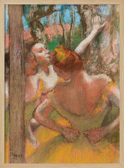 An Impressionist pastel drawing by Edgar Degas depicting several ballet dancers backstage. A dancer with reddish-orange hair is seen from behind in a yellow-green costume, while another dancer stretches an arm upwards. The background is a textured blend of blue, pink, and green. Decor