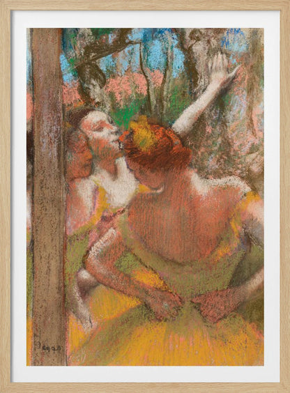 An Impressionist pastel drawing by Edgar Degas depicting several ballet dancers backstage. A dancer with reddish-orange hair is seen from behind in a yellow-green costume, while another dancer stretches an arm upwards. The background is a textured blend of blue, pink, and green. Decor