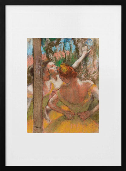 A framed art print of an impressionistic pastel painting by Edgar Degas featuring several ballet dancers backstage. A central figure, seen from behind, adjusts her yellow-green tutu while other dancers stretch in the background. Artwork
