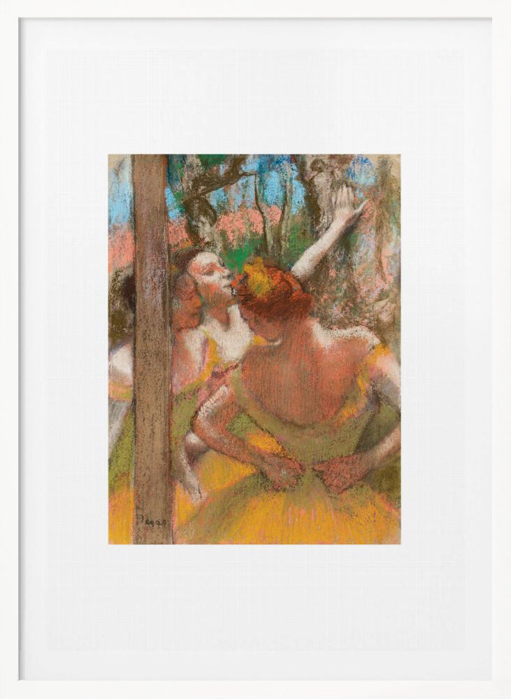 A framed art print of an impressionistic pastel painting by Edgar Degas featuring several ballet dancers backstage. A central figure, seen from behind, adjusts her yellow-green tutu while other dancers stretch in the background. Artwork