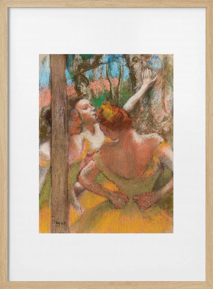 A framed art print of an impressionistic pastel painting by Edgar Degas featuring several ballet dancers backstage. A central figure, seen from behind, adjusts her yellow-green tutu while other dancers stretch in the background. Artwork