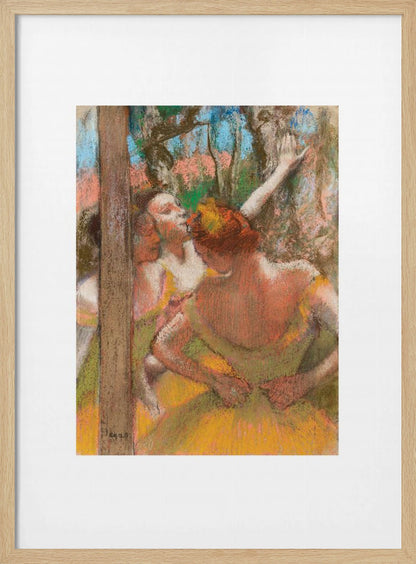A framed art print of an impressionistic pastel painting by Edgar Degas featuring several ballet dancers backstage. A central figure, seen from behind, adjusts her yellow-green tutu while other dancers stretch in the background. Artwork
