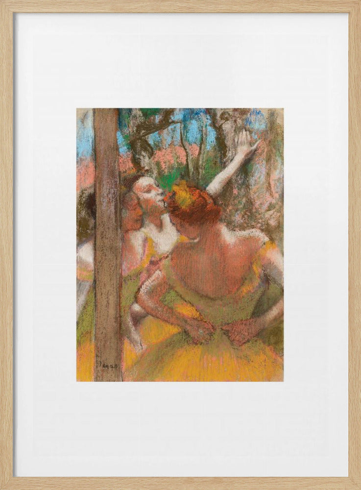 A framed art print of an impressionistic pastel painting by Edgar Degas featuring several ballet dancers backstage. A central figure, seen from behind, adjusts her yellow-green tutu while other dancers stretch in the background. Artwork