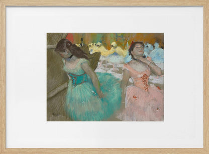 An impressionist pastel painting by Edgar Degas of two ballerinas backstage. One in the foreground wears a teal tutu and looks down, while another beside her in a pink tutu adjusts her choker. Other dancers are visible in the background under warm stage light. Poster