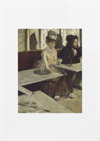 A framed print of Edgar Degas's painting 'L'Absinthe,' depicting a somber-looking man and woman sitting at adjacent tables in a 19th-century Parisian cafe, conveying a sense of alienation and melancholy. Print