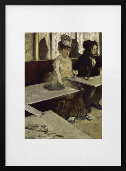 A framed print of Edgar Degas's painting 'L'Absinthe,' depicting a somber-looking man and woman sitting at adjacent tables in a 19th-century Parisian cafe, conveying a sense of alienation and melancholy. Print