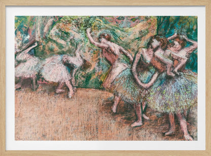 An Impressionist painting by Edgar Degas of ballet dancers on a stage against a green and orange backdrop. The dancers, in various poses, wear tutus in shades of white, pink, and light green. The artwork is framed in a simple silver frame. Artwork