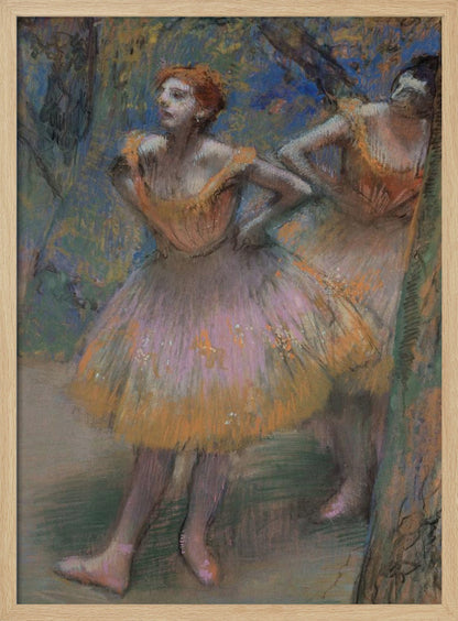 An impressionist pastel painting by Edgar Degas of two ballet dancers. The main dancer in the foreground has red hair and wears a pink and orange tutu. She stands with her hands on her hips, looking off to the left. The background is a blend of blue and green strokes, suggesting a backstage or outdoor setting. Decor