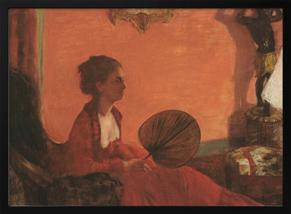 A vintage painting of a woman in profile sitting in a chair against a warm, orange-toned wall. She is wearing a red dress with a white ruffled collar and holding a dark, circular fan in her lap. The room is softly lit, with shadows and a small statue visible in the background. Wall Art