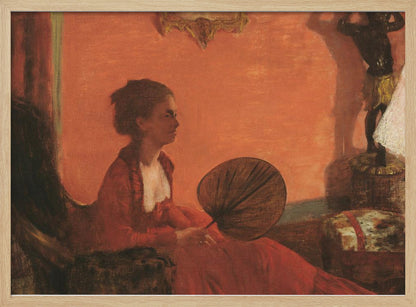 A vintage painting of a woman in profile sitting in a chair against a warm, orange-toned wall. She is wearing a red dress with a white ruffled collar and holding a dark, circular fan in her lap. The room is softly lit, with shadows and a small statue visible in the background. Wall Art