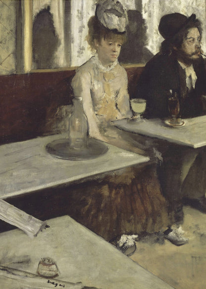 An impressionist painting by Edgar Degas, 'L'Absinthe', depicting a man and a woman sitting separately in a cafe. The woman in a light dress and hat looks downcast before a glass of pale green absinthe, while the bearded man next to her smokes a pipe and looks to the right. The scene is captured from an angle, with empty cafe tables in the foreground. Poster