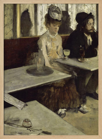 An impressionist painting by Edgar Degas, 'L'Absinthe', depicting a man and a woman sitting separately in a cafe. The woman in a light dress and hat looks downcast before a glass of pale green absinthe, while the bearded man next to her smokes a pipe and looks to the right. The scene is captured from an angle, with empty cafe tables in the foreground. Poster