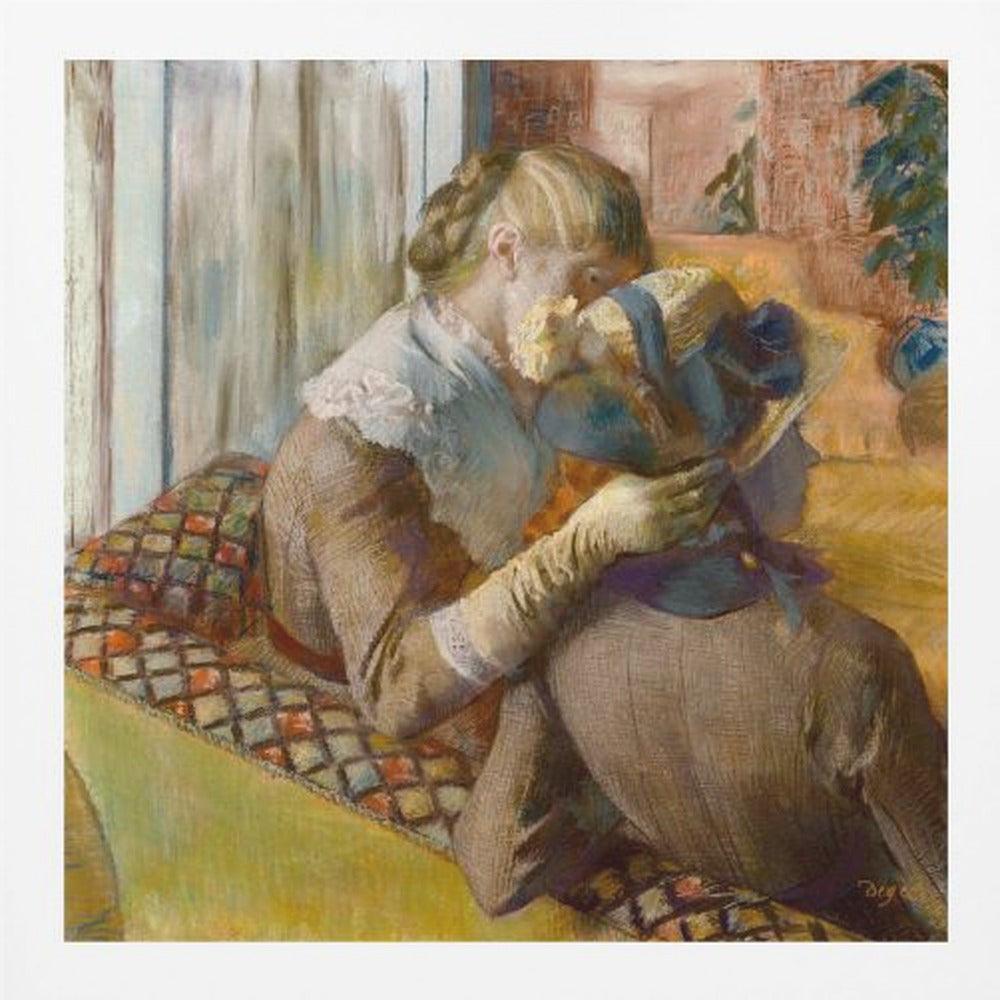 A framed Impressionist painting by Edgar Degas depicting two women. One woman, with blonde hair tied back, adjusts a hat with a blue ribbon on the other woman who is sitting with her back mostly to the viewer on a colorful patterned sofa. Print