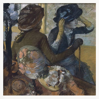 A framed impressionist painting by Edgar Degas, 'The Millinery Shop', depicting two women. One woman, seen from the back, wears a brown coat and hat, while the other tries on a dark blue hat, adjusting it with her gloved hands. Colorful hats are displayed in the foreground. Print