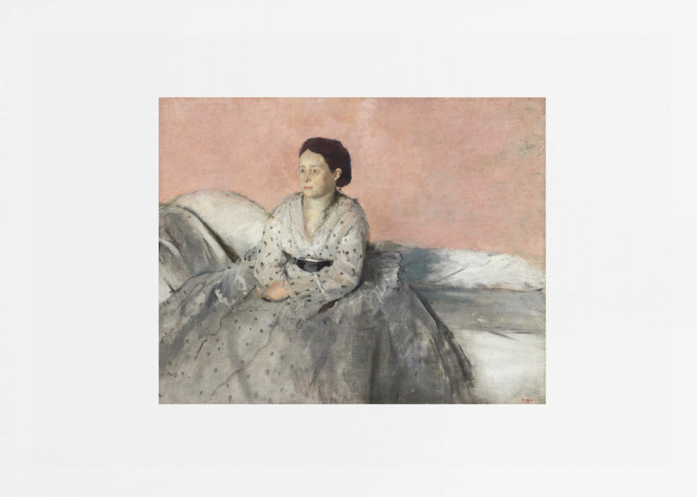 A framed impressionist painting of a woman with dark hair sitting on a bed against a dusty rose background. She wears a white, dotted blouse and a voluminous gray skirt, looking thoughtfully to her left. The painting is set in a silver frame with a white mat. Poster